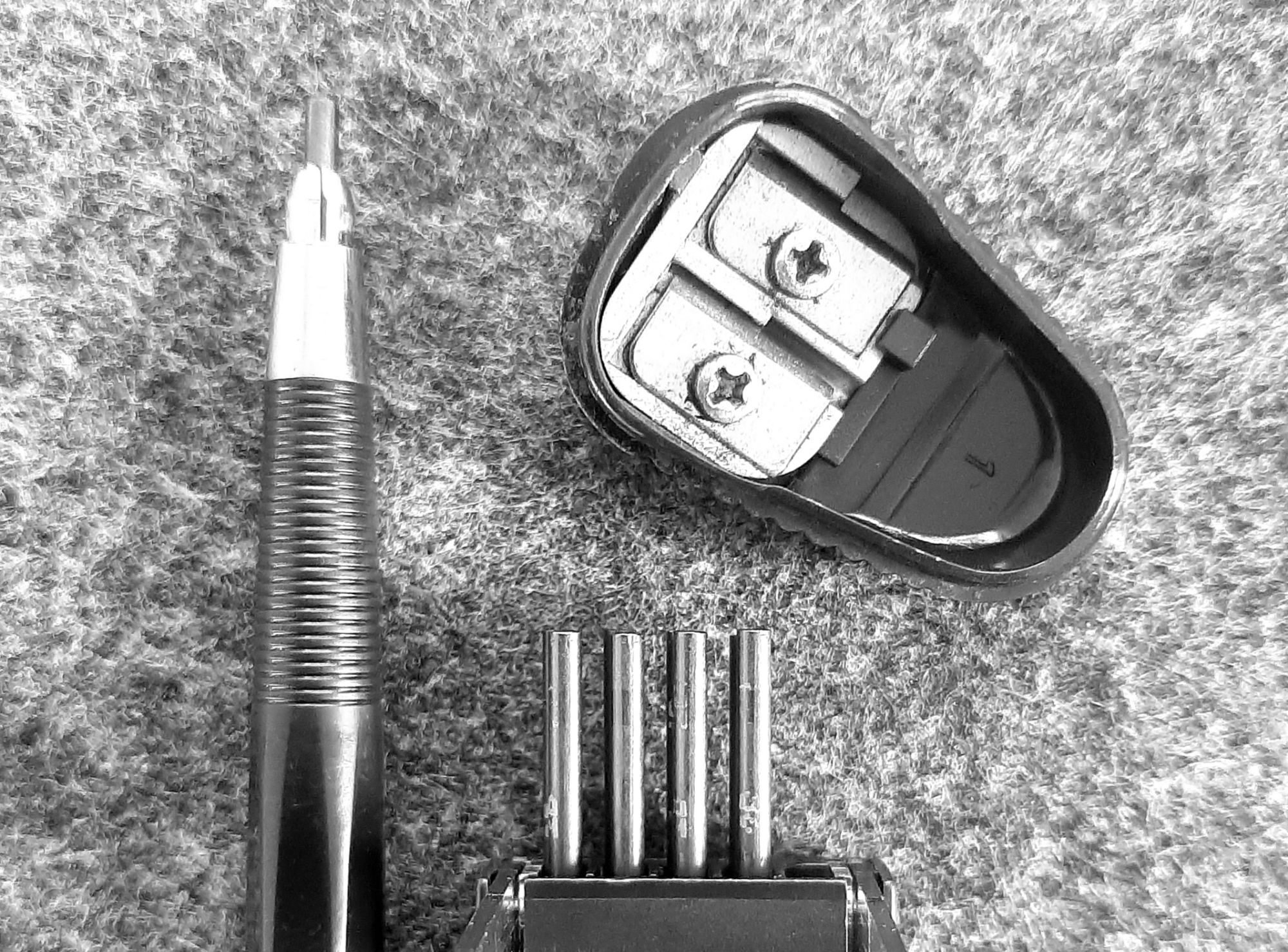 ein Fallminenstift mit Ersatzminen und Spitzer auf einer Filzunterlage